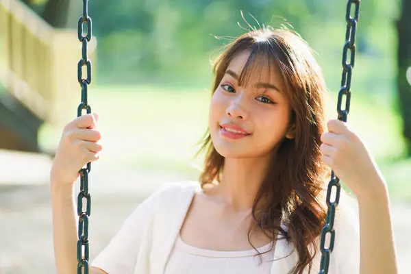Portrait shot of happy optimistic Asian woman, successful, attractive Asian woman with big smiling and confident, Unaware scene of happy emotion of young healthy woman in natural lifestyle in the park