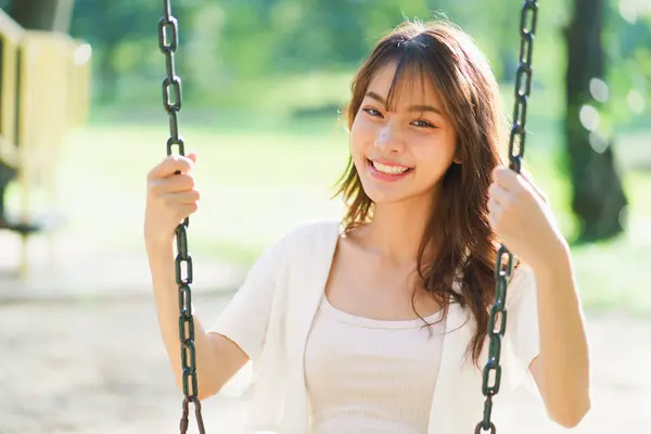 Portrait shot of happy optimistic Asian woman, successful, attractive Asian woman with big smiling and confident, Unaware scene of happy emotion of young healthy woman in natural lifestyle in the park