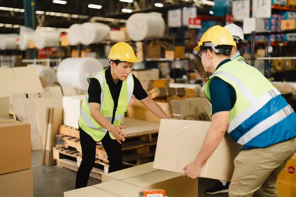 Group of Asian industrial worker has working together at warehouse factory workplace. Candid Industrial worker has inspected packaging to quality check scene, Auditor people working onsite.