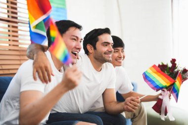 Sevgililer Günü 'nü birlikte kutlarken oturma odasında oturan üç kişi. LGBTQ insanları yaşam tarzı ve duyguları seviyor.