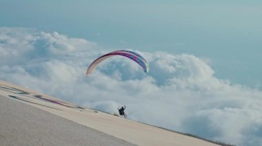 Yerden kalk, bir paraglider uçur, bulutların üzerinden uç. Cesaret özgürlüğü kavramı. Yüksek kalite 4k görüntü