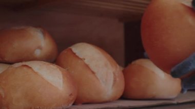 Ağır çekim. Fırıncı elleri koruyucu eldivenlerde, fırından taze taze ekmek soğutmak için özel bir dolaba konur. Küçük bir iş, küçük bir kasabada hayat. Gerçek bir pastanede Tahsilat Günü