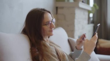 Woman makes purchase online store using plastic credit card and cell phone. Using modern banking app technology, travel plan, hotel reservation, buying from a distance, secure payment concept, SLO MO