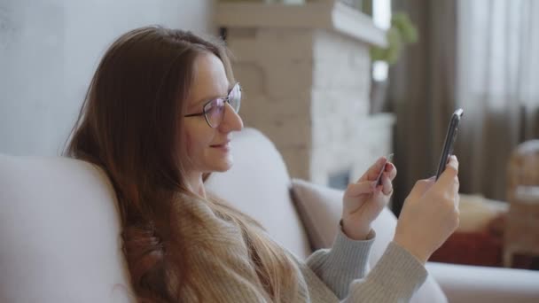 Tevreden Jonge Vrouw Creditcardhouder Gebruikt Telefoon Online Aankopen Betalen Consumptiegoederen — Stockvideo