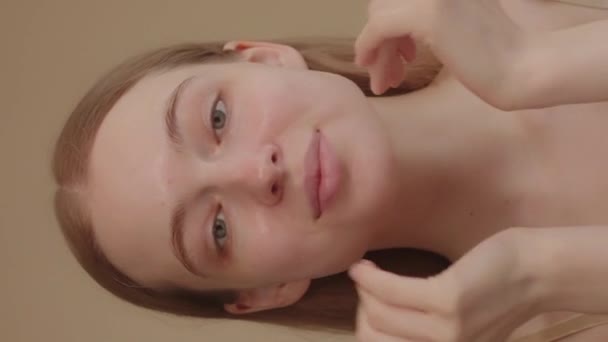 Young Lady Blue Eyes Applies Serum Her Face Looking Camera — Vídeo de Stock
