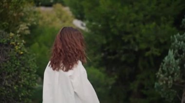 Tarz sahibi bir kadın saçı rüzgarda dalgalanırken doğada tek başına dolaşır. Güç ve özgürlük yayıyor. Genç bir kız zahmetsiz bir zarafetle dönüp kameraya bakıyor. Yavaş çekim