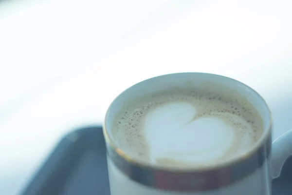 A cup of cafe latte with heart-shaped latte art