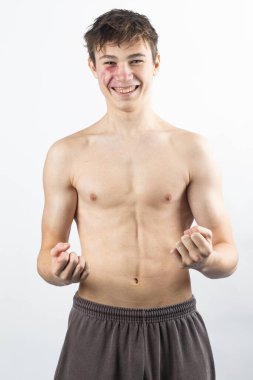 A portrait of a 17 year old shirtless muscular teenage boy
