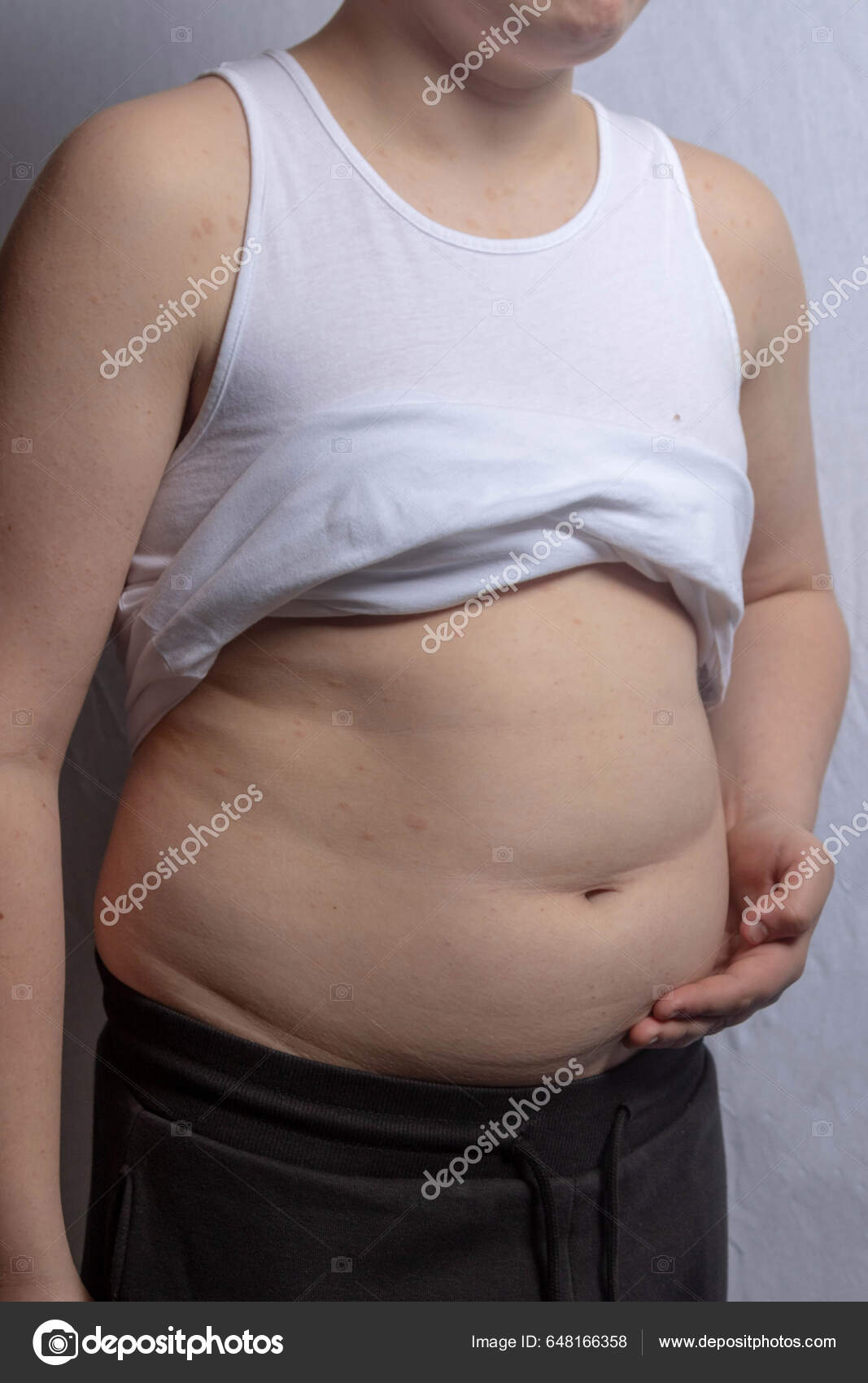 Overweight Shirtless Caucasian Teenage Boy Wearing Sleevless Top Showing  His Stock Photo by ©Triumph0828 648166358