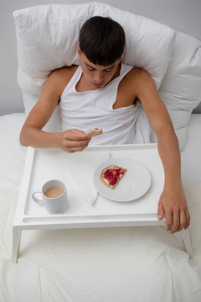 stock image Young single adult man having breakfast in bed