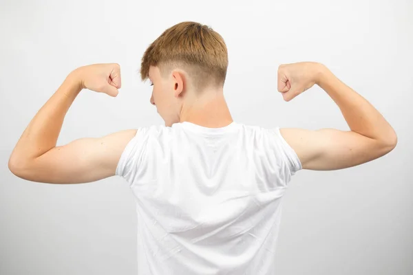 Teenage Boy Flexing Both His Arms — Stock Photo, Image