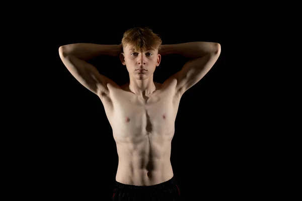stock image Portrait of a sporty shirtless teenage boy flexing his muscles