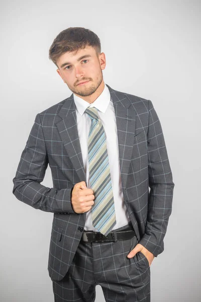 スーツの若い起業家の肖像画とジャケットを平凡な背景に保持するネクタイ — ストック写真