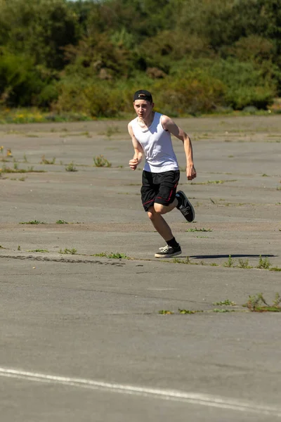 Fit Sporty Teenage Boy Wearing Backwards Cap Running Outsid Eon — Stock Photo, Image