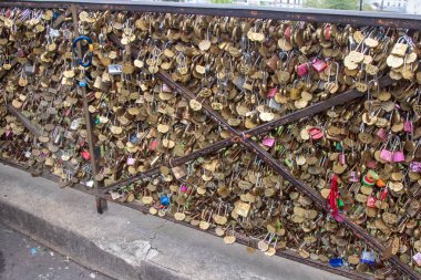 Paris, France, Apirl 20th 2024:- A view of padlocks attached to railings near the Sacre Coeur on Montmartre clipart