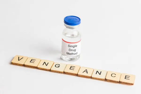 stock image A Medical Vial with a label reading Singel Drug Method with a sign reading Vengeance