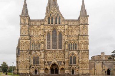 Salisbury, United Kingdom, 25th August 2024:- A view of the main entrance to Salisbury Cathedral, possessing the tallest church spire in the UK at 404 feet. clipart