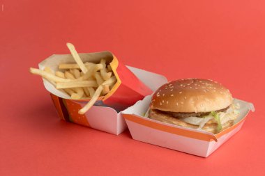 Londra, Birleşik Krallık, 14 Ekim 2024: - McDonalds Big Mac ve Medium Fires 'ın kırmızı zemin üzerindeki görüntüsü
