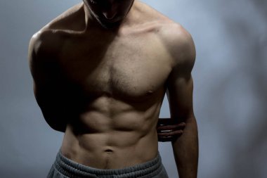 Karın kasları ve göğsü iyi tanımlanmış genç bir erkek cesedi. Gömleksiz gövdeli bir model. Vücut bakımı, erkek sağlığı, fitness, gençlik, erkeklik, sağlık, kilo kaybı, vücut geliştirme 