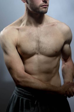Karın kasları ve göğsü iyi tanımlanmış genç bir erkek cesedi. Gömleksiz gövdeli bir model. Vücut bakımı, erkek sağlığı, fitness, gençlik, erkeklik, sağlık, kilo kaybı, vücut geliştirme 