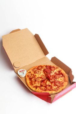 London, United Kingdom, 5th November 2024: A view of Dominos 9 Margherita pizza and small BBq dip, against a White Background clipart