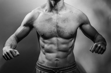Karın kasları ve göğsü iyi tanımlanmış genç bir erkek cesedi. Gömleksiz gövdeli bir model. Vücut bakımı, erkek sağlığı, fitness, gençlik, erkeklik, sağlık, kilo kaybı, vücut geliştirme 