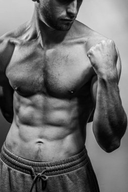Karın kasları ve göğsü iyi tanımlanmış genç bir erkek cesedi. Gömleksiz gövdeli bir model. Vücut bakımı, erkek sağlığı, fitness, gençlik, erkeklik, sağlık, kilo kaybı, vücut geliştirme 
