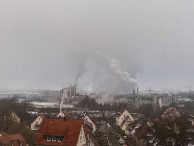 Environmental problem of pollution of environment and air in cities. Smoking industrial zone factory chimneys. View of large plant with Smoking pipes Smoke from the paper industry, which is running
