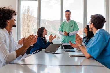 İş dünyasının takım liderliği konseptinde düzenlenen toplantıda doktorlar destekliyor ve alkışlıyorlar.