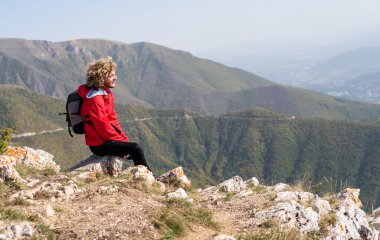 Yürüyüşe çıkan bir adam dağın tepesine, aktif ve sağlıklı bir yaşam tarzına bakmak ister. Yüksek kalite fotoğraf
