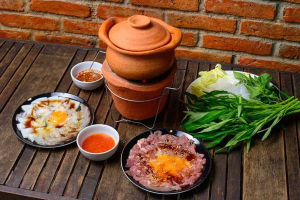 Hot pot thai style. Hot pot with clear soup in the clay cooking pot.