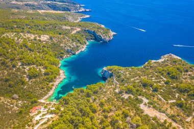 A breathtaking aerial view of Tatinja Beach on the southern coast of Solta Island, Croatia, featuring crystal-clear turquoise waters, a pristine shoreline, and yachts anchored nearby, making it a perfect summer yachting and sailing destination. clipart