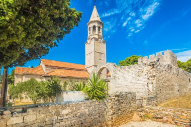 A historic view of the Christian Basilica of St. John the Baptist in Povlja on Brac Island, Croatia, showcasing its ancient stone architecture, cultural heritage, and divine Mediterranean surroundings clipart