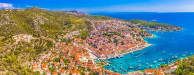 Hırvatistan 'ın Hvar Adası' ndaki Hvar Eski Kasabası 'nın nefes kesici panoramik manzarası tarihi terracotta çatıları, büyüleyici bir liman ve Dalmaçya' nın kalbinde canlı Adriyatik kıyı şeridi sergileniyor.