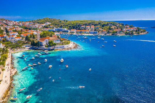 Scenic view of amazing Krizna Luka on Hvar Island, Croatia, showing a breathtaking coastline with turquoise Adriatic Sea, and sunbathers enjoying the nautical summer season