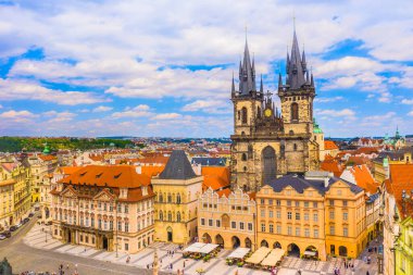 Prag ortaçağ meydanının insansız hava aracı görüntüsü kırmızı çatıları, tarihi binaları, kiliseleri ve açık yaz gökyüzünün altında panoramik bir silueti olan eski şehrin güzel sokaklarını gösteriyor.
