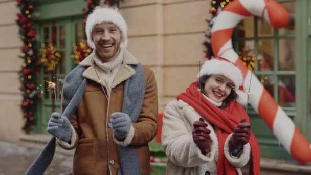 Joyful Couple Love Holding Sparklers While Standing Decorated Xmas Street — Stock Video