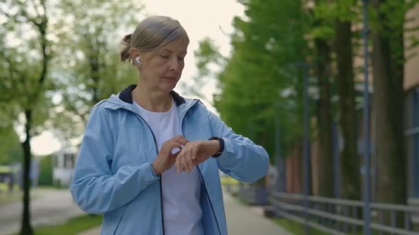 Sportlich Reife Läuferinnen Die Mit Smart Watch Technik Auf Der — Stockvideo
