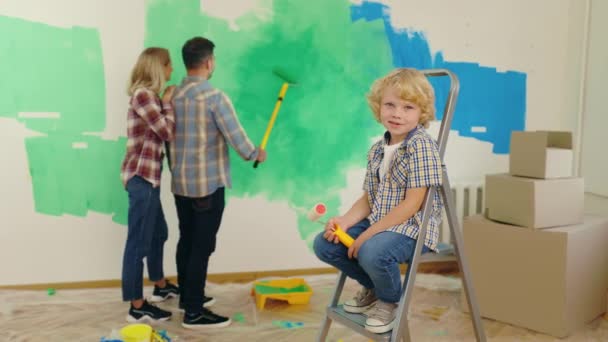 Portrait Little Caucasian Boy Sitting Stepladder New Apartment Holding Paint — Stock Video