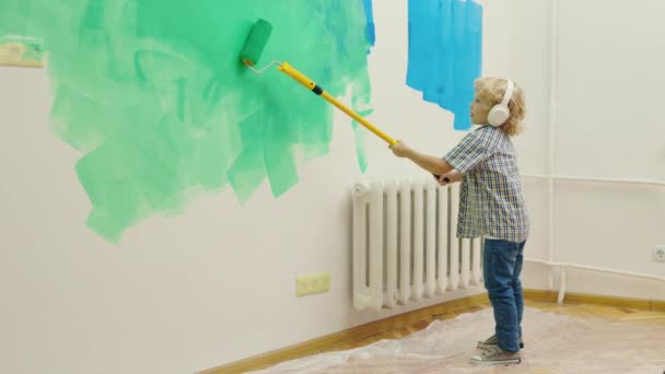 Child Painting Wall Paint Roller While Listening Music Adorable Small — Stock Video