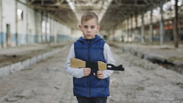 Child Holds Toy Gun Standing Background Devastation Looking Camera Portrait — Vídeo de stock