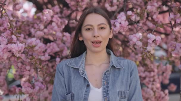 Portrait Charming Young Brunette Blowing Out Palms Tender Petals Sakura — Vídeo de stock