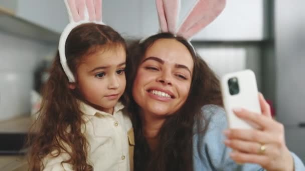 Smiling Mother Daughter Doing Selfie Easter Eggs Wearing Bunny Ears — Stockvideo