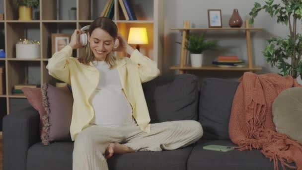 Relaxed Woman Expectation Sitting Couch Listening Music Wireless Headphones Young — Wideo stockowe