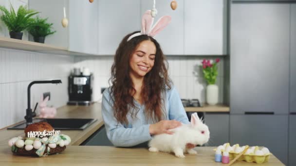 Portrait Happy Woman Bunny Ears Caressing Rabbit Decorated Kitchen Looking — Stock Video