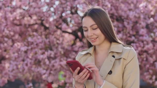 Smiling Caucasian Woman Long Brown Hair Using Modern Smartphone Scrolling — Stockvideo