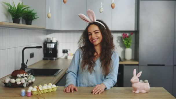 Portrait Happy Woman Wearing Bunny Ears Headband Sitting Decorated Kitchen — Stock Video