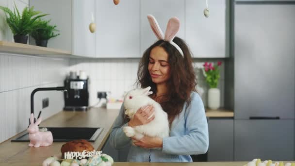 Portrait Happy Woman Bunny Ears Holding Rabbit Decorated Kitchen Getting — Stock video