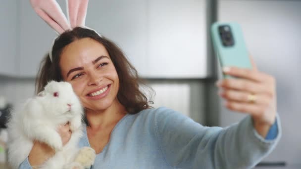 Portrait Happy Woman Wearing Bunny Ears Taking Picture Playing Baby — Stock video
