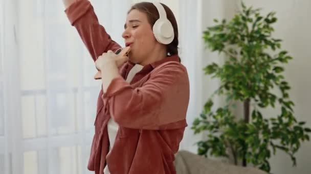Happy Young Woman Headphones Dancing Singing Smartphone Having Fun Living — Αρχείο Βίντεο